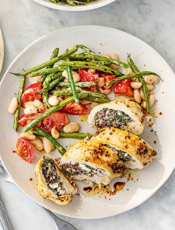 Spinach, cheese and olive stuffed chicken with two-bean salad