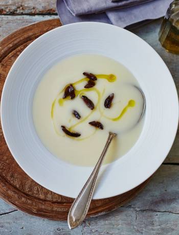 Velvety potato soup with black olives and truffle oil
