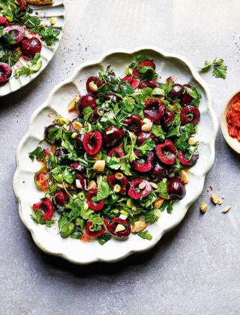 Fresh herb salad with cherries and almonds