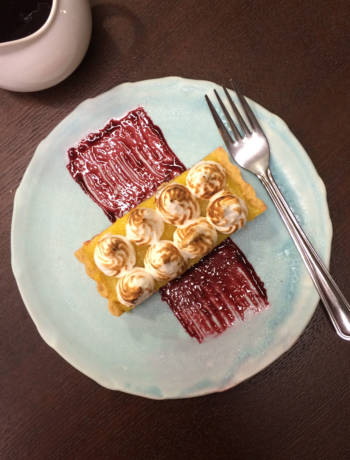 Lemon meringue tart with blackberry coulis