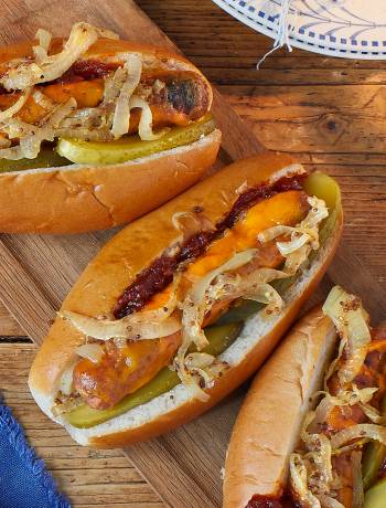 Melting cheese dogs with mustard onions