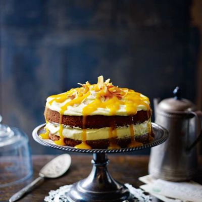 Coconut cake with mango cream cheese frosting and mango drizzle