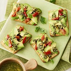 Chive crispbreads with avocado, semi-dried tomato and pesto topping