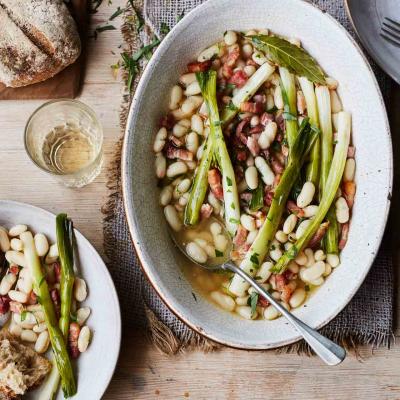 Slow-cooked spring onions with cannellini, bacon and tarragon