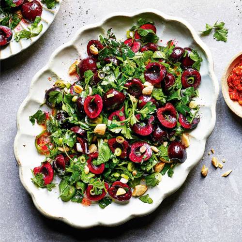 Fresh herb salad with cherries and almonds