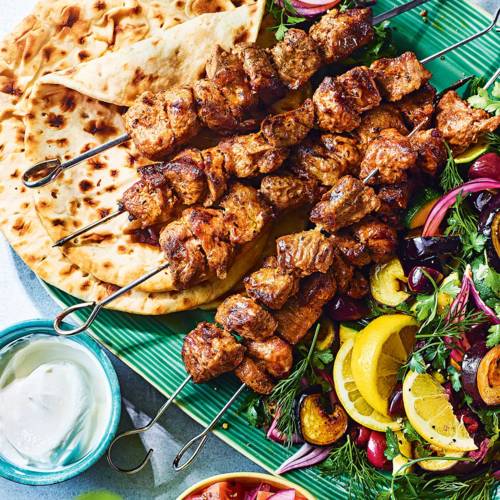 Mayo-marinated lamb skewers with aubergine, courgette and olive salad