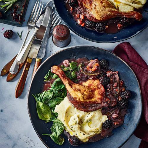 Braised duck legs with blackberries and celeriac mash