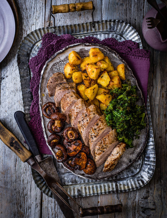Recipe: Roast pork with balsamic mushrooms, crispy potatoes & kale