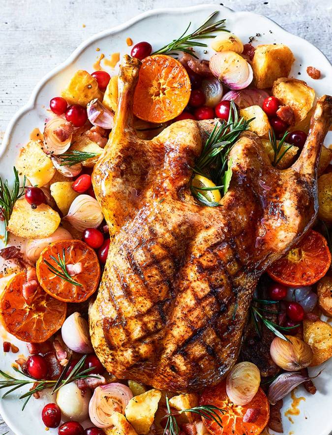 Sticky citrus roast duck with crispy potatoes recipe | Sainsbury's Magazine