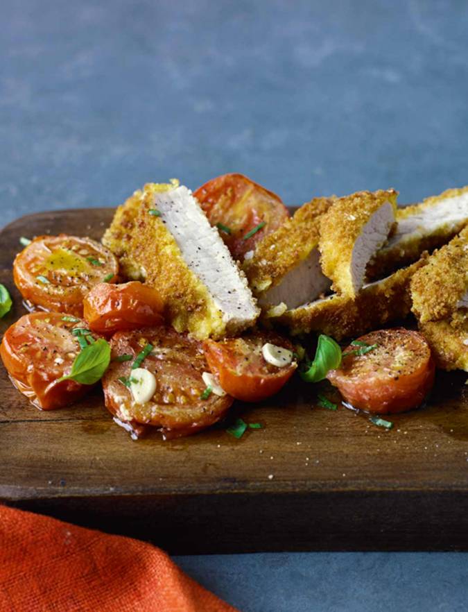 Recipe: Parmesan-crumbed pork with roasted tomatoes