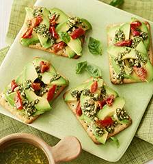 Chive crispbreads with avocado, semi-dried tomato and pesto topping