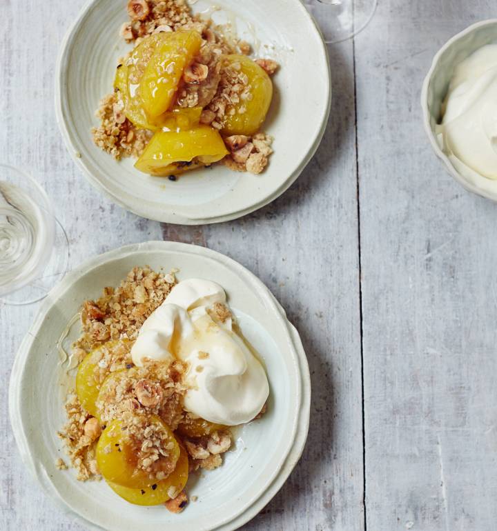 Baked plums with cardamom and honey, oat crumble and whipped cream