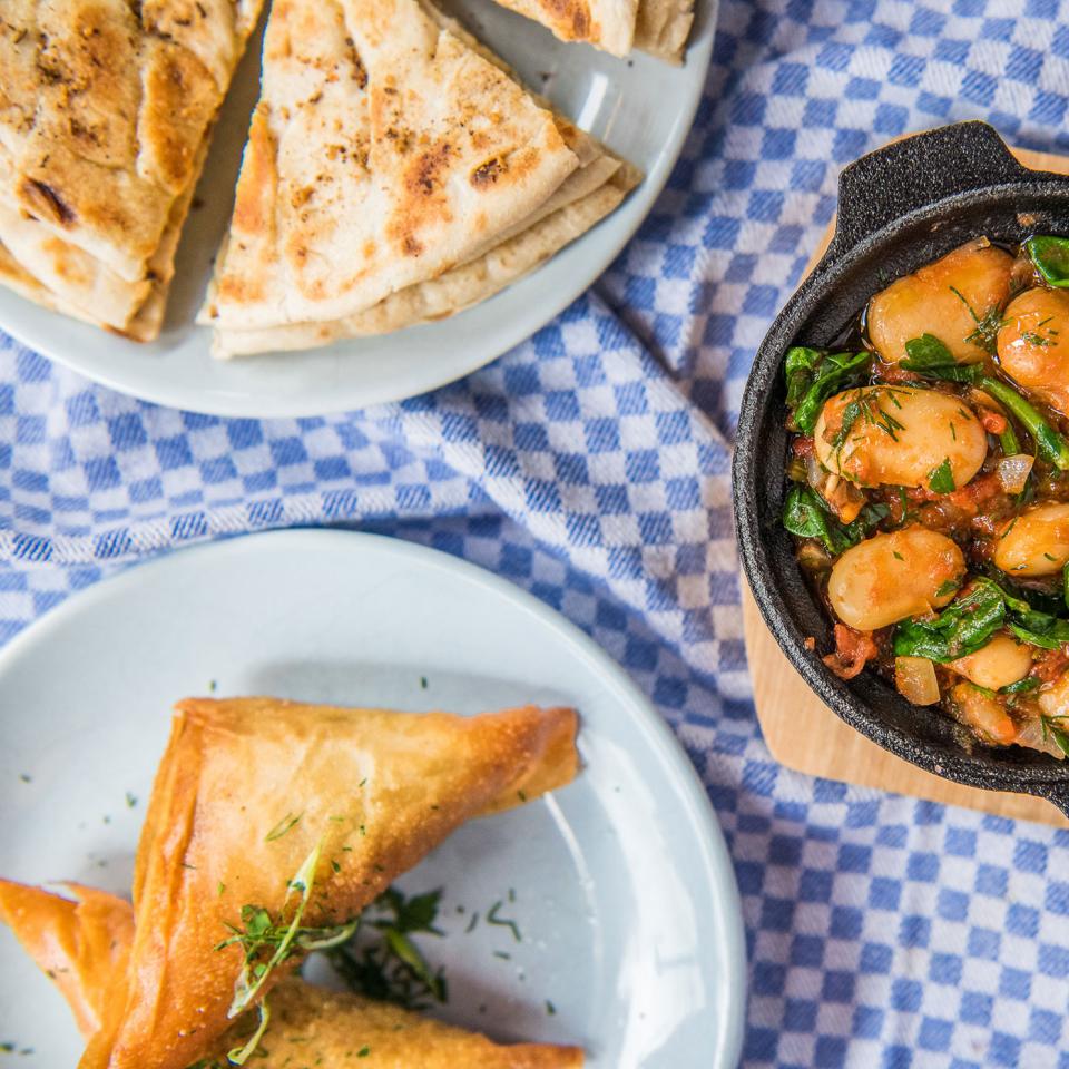 Greek flatbread, chickpea filo triangles and spinach with gigantes