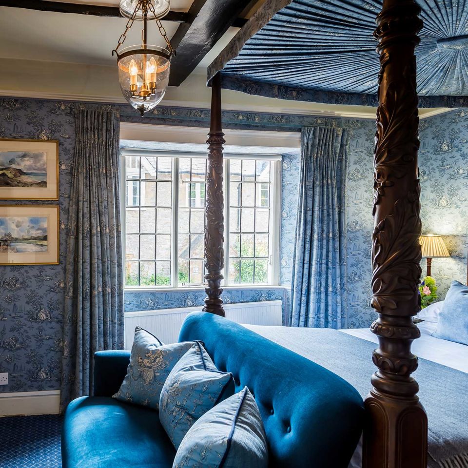 Traditional florals and four-poster beds in the bedrooms