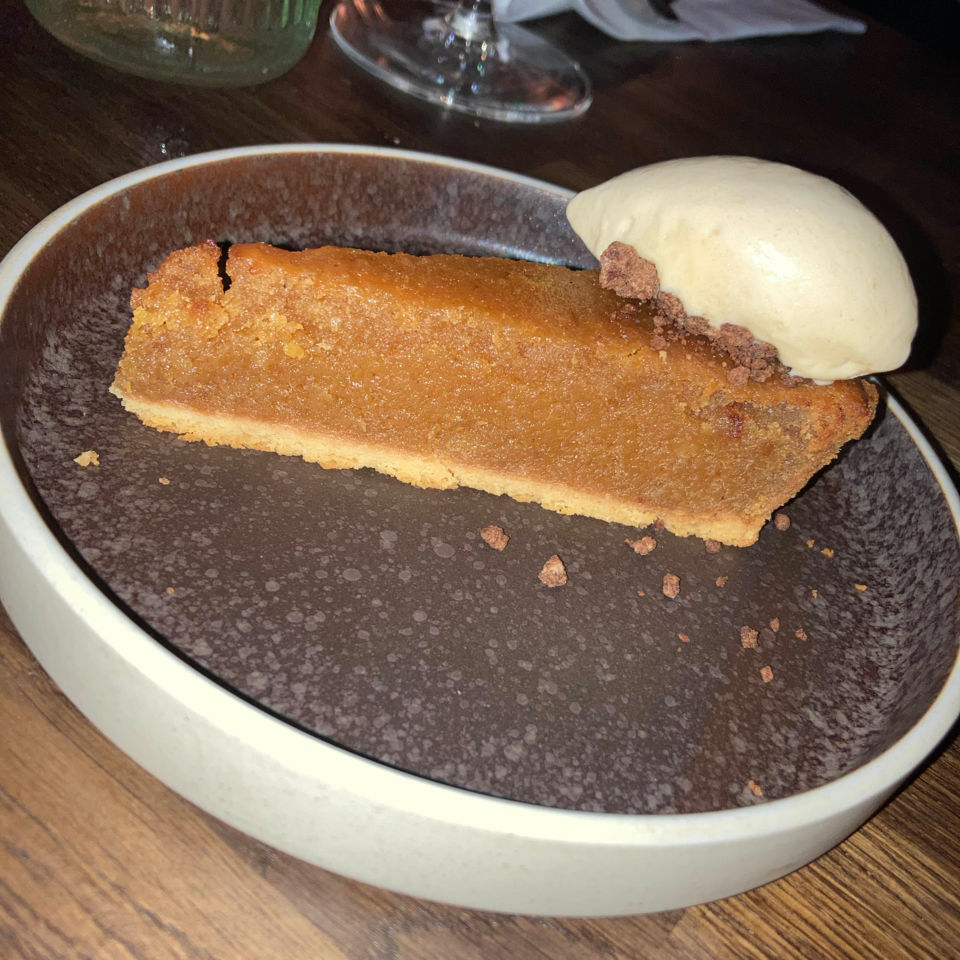 A wedge of treacle tart, with ice-cream