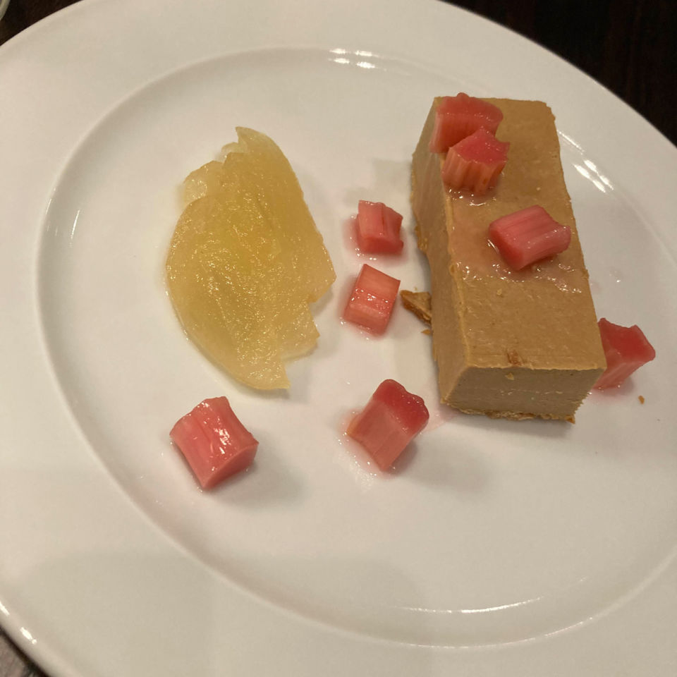 A slice of salted caramel tart, with poached rhubarb and Braeburn apple