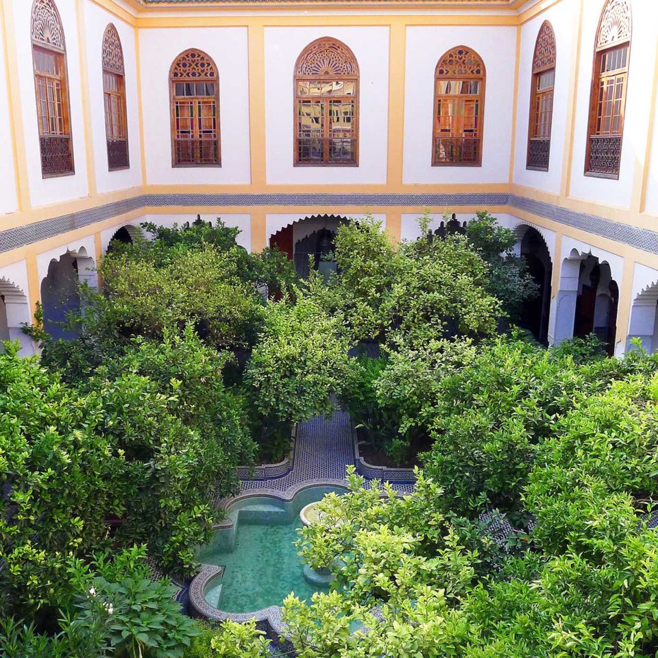 Palais Amani's courtyard with lemon trees and a trickling fountain