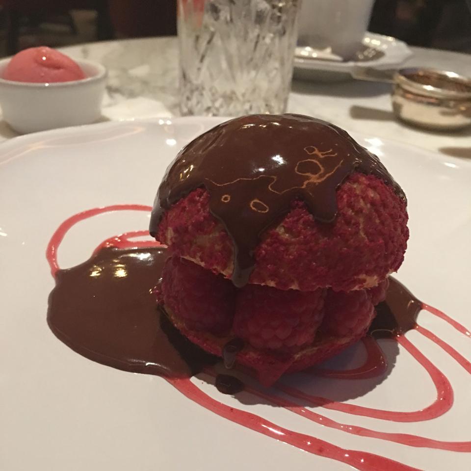 Raspberry choux bun with warm chocolate sauce