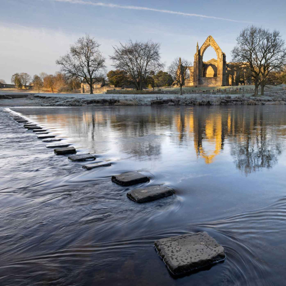 Stepping stones leading to Bolton Abbey Priory. Credit: Alamy