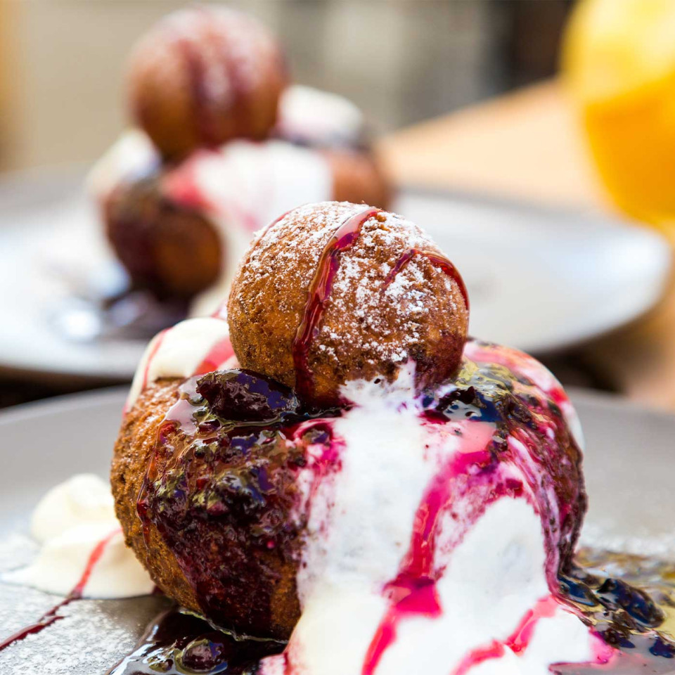 Sweet cheese papanași doughnuts served with blueberries and soured cream. Credit: Getty.